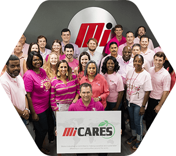 group of volunteers holding Mi CARES poster