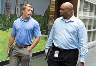 Three women walking inside a corporate office