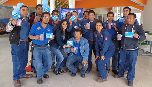 Group picture with people smiling and holding up papers