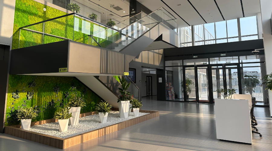 Lobby and stairs area in Jinshan plant filled with sunlight and green backdrop wall