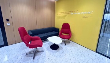 Seating area in lobby with quote on wall mural