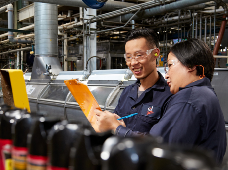 Two SCJ team members working on manufacturing line
