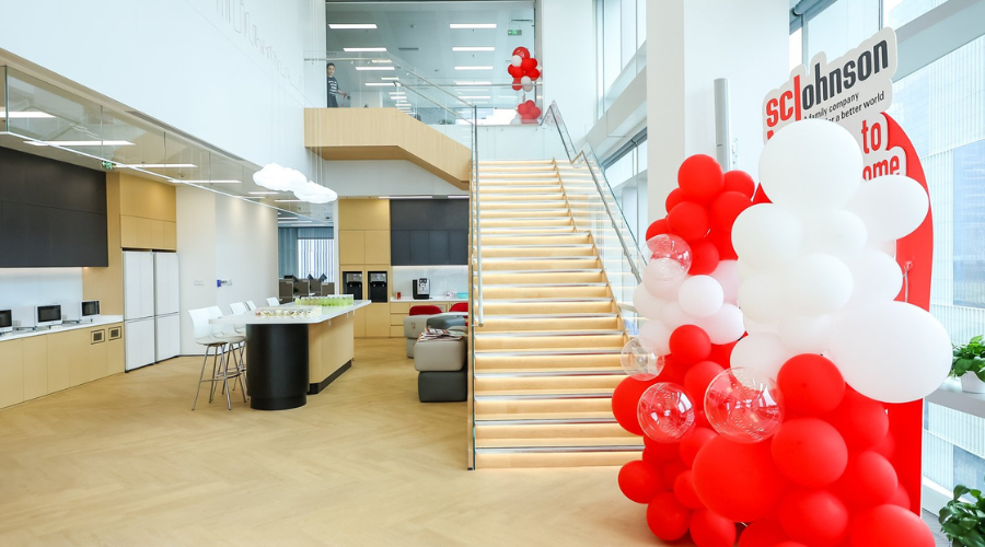 Lobby of Shanghai office with red and white balloons at bottom of staircase