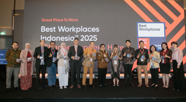 Indonesia team members on stage accepting award at Great Place to Work event