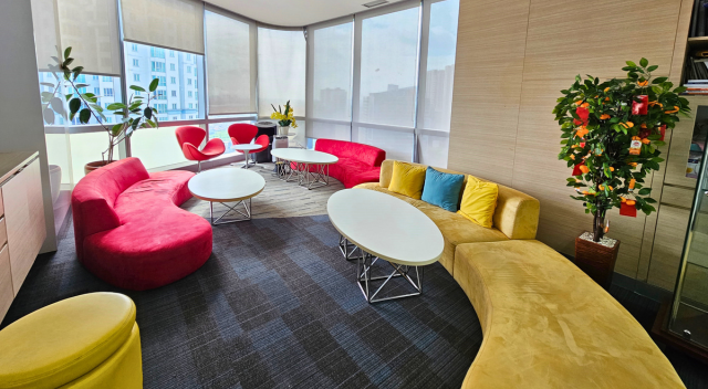 Seating area with colorful couches and low tables