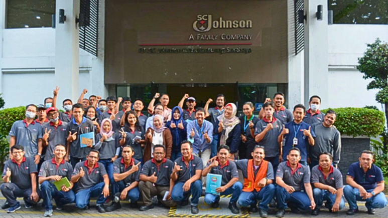 Group photo of Surabaya team in front of manufacturing facility