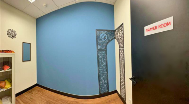 Prayer Room sign on door with graphic detail on wall