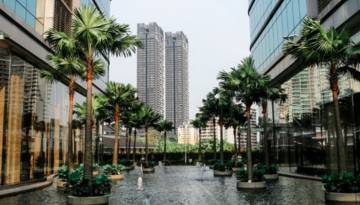 Outdoor view of courtyard with pool and tall buildings in background