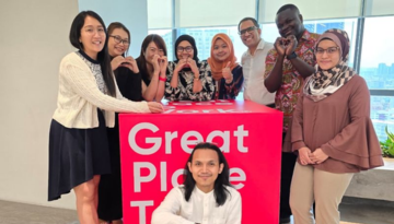 Malaysia team members posing with Great Place to Work sign