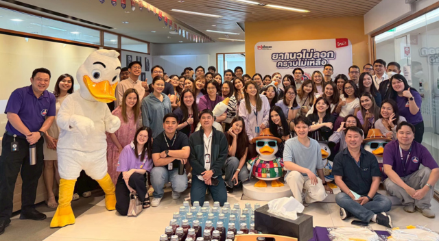 Group photo of Thailand team in lobby of office