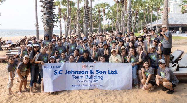 SCJ Thailand team holding banner at beach clean up event