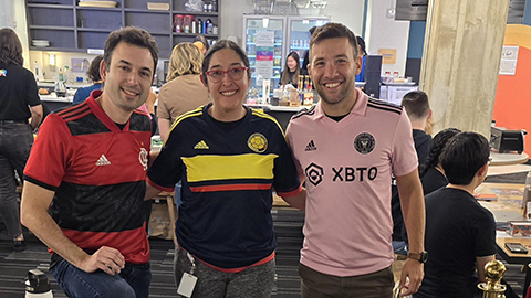 Three team members in soccer jerseys