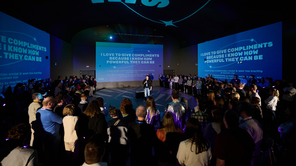 Group of LSB team members surrounding a person in the middle with an inspirational quote behind them