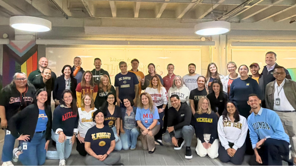 Group photo of San Francisco LSB team members dressed in gear from their alma mater