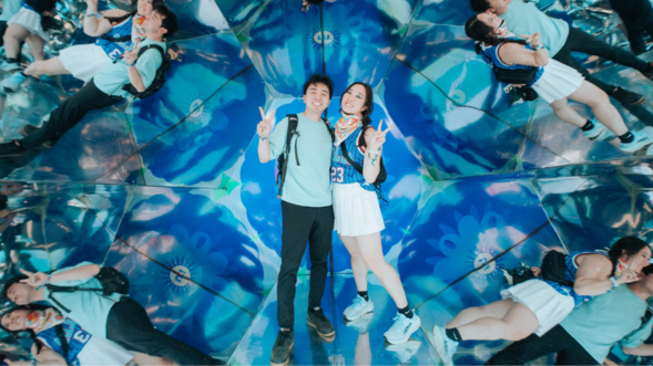 Two Coachella fairgoers experiencing method kaleidoscope exhibit