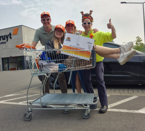 LSB team members posing in a shopping cart on Retail Safari