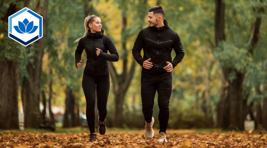 Two individuals hiking in the woods in fall