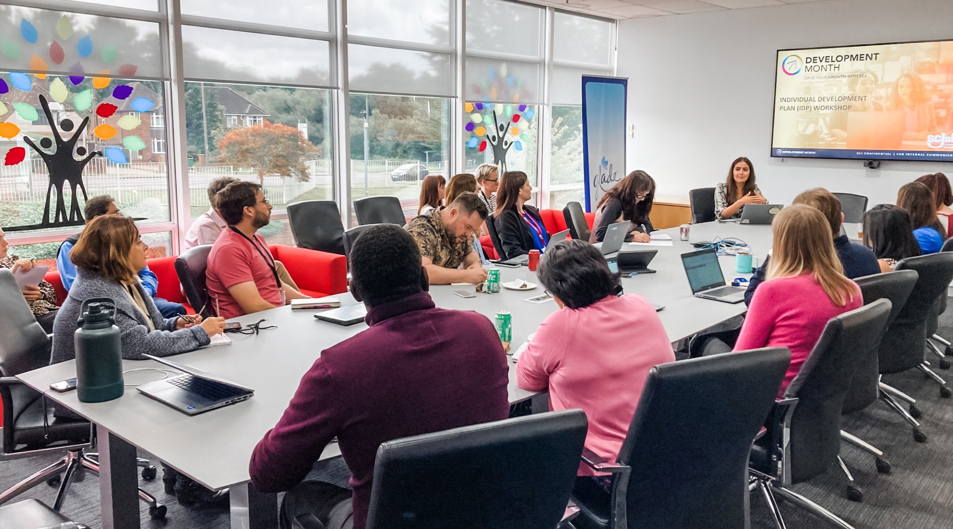 SCJ people sitting around a conference table participating in a virtual Development Month event