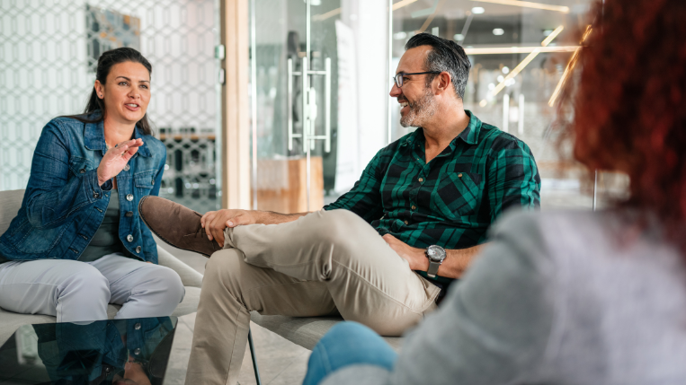 Three team members sitting together having a discussion