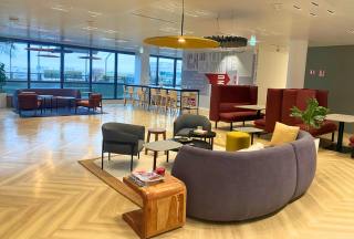 Seating area with couch and chairs overlooking office