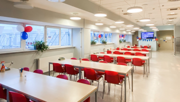 Indoor view of seating area with windows in the background