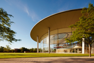 Exterior of circular building with airplane inside as a display