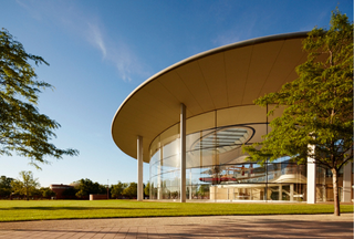 Exterior of Racine's Forteleza Hall in the sunlight with view of plane inside building