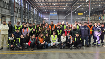 Pilar team posing for a group photo in warehouse area