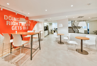 Seating area with "Doing what's right never gets old" mural text on wall