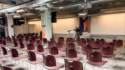Commons area with chairs and front screen and white board area