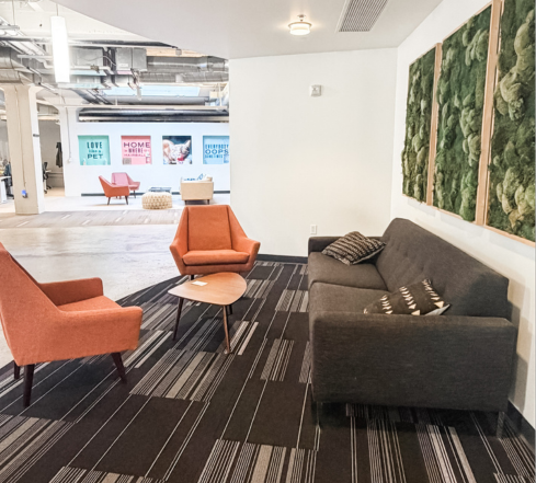 Seating area with couch, chairs and LSB branding displays in background