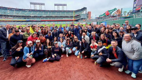 Group photo of LSB San Francisco team at a baseball game