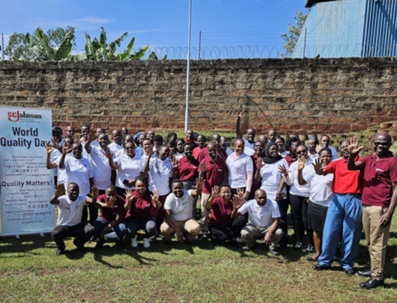 SCJ Nairobi team photo with Quality Day banner