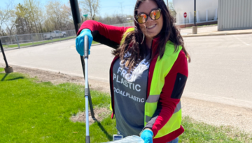 Team member picking up litter at Earth Month volunteering event