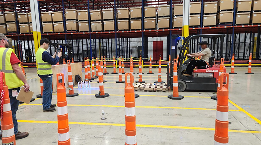 Team member driving fork lift through skills test course