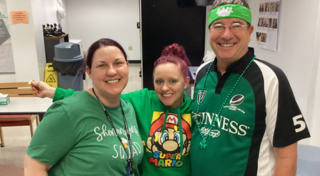 Three team members dressed in St. Paddy's Day attire