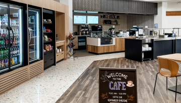 Cafeteria area with cold cases stocked in background