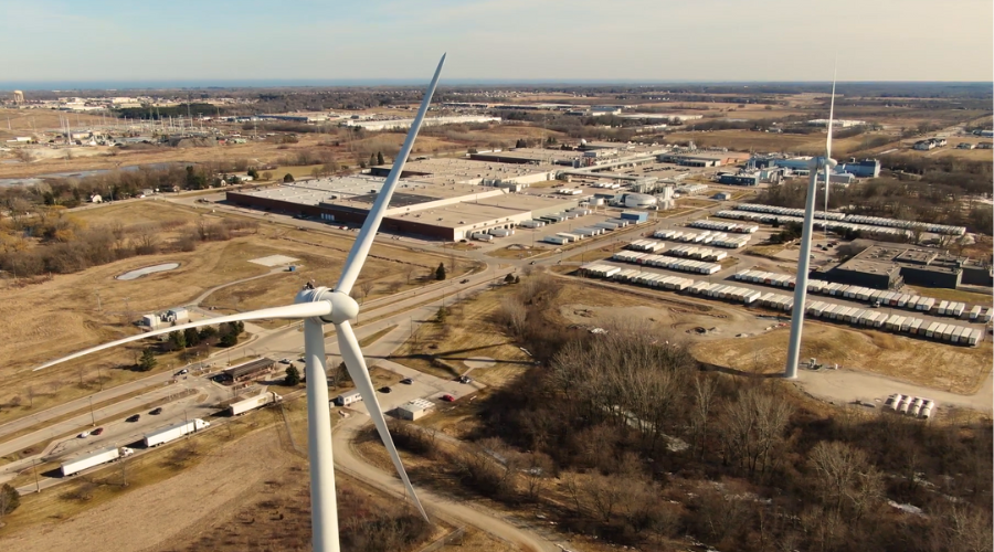 Aerial image of Waxdale manufacturing facility with two wind turbines in foreground