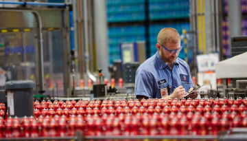 Manufacturing line with worker examining product