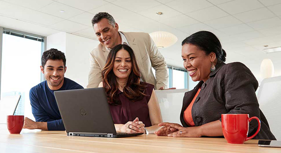Employees smiling at computer screen