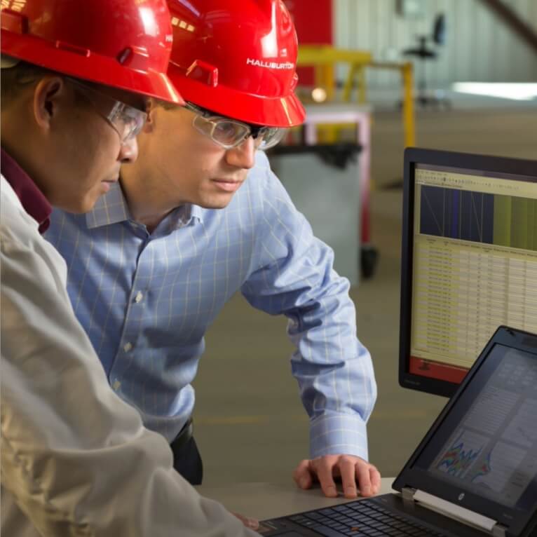 Two people looking at a laptop screen