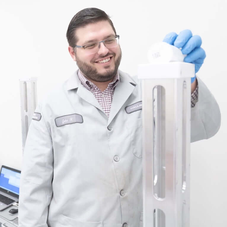 A man holding up a cylinder