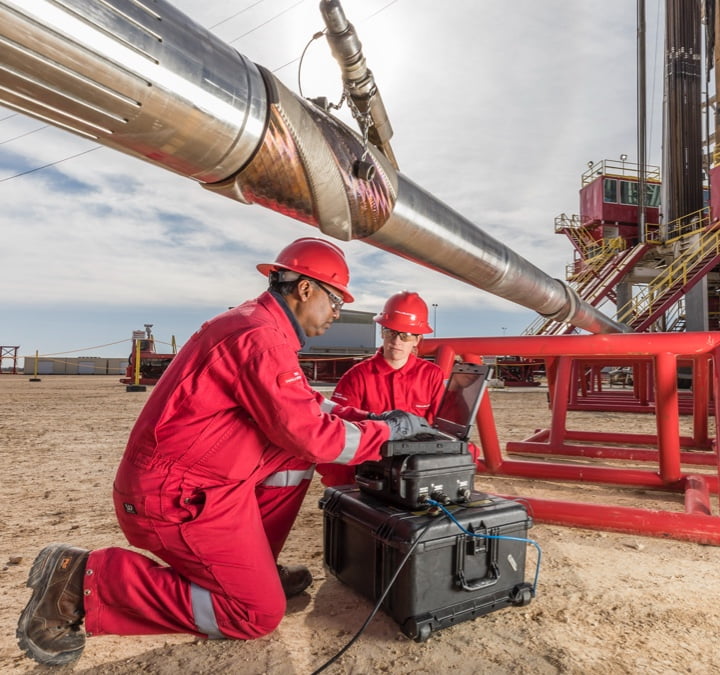 Two people working in red coveralls