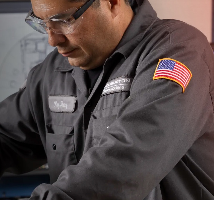 Man wearing grey uniform and protective glasses