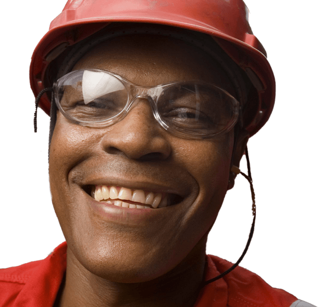 Man with red hard hat and protective glasses smiling