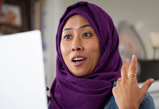Malaysian Woman in Home Office Standing at Desk