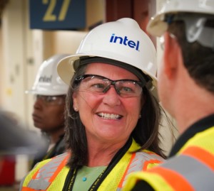 Woman smiles at man while in group of construction employees 