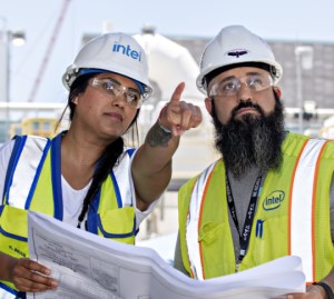 Woman and Man with Blueprint pointing  