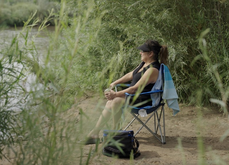 Employee sits on a chair by a river in New Mexico