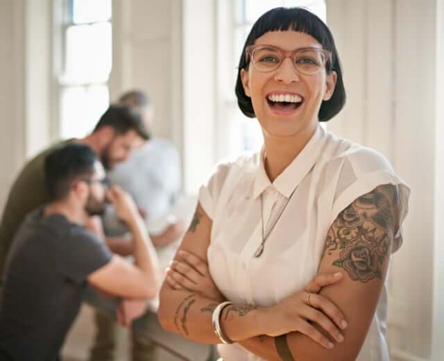 woman with tattoos laughing
